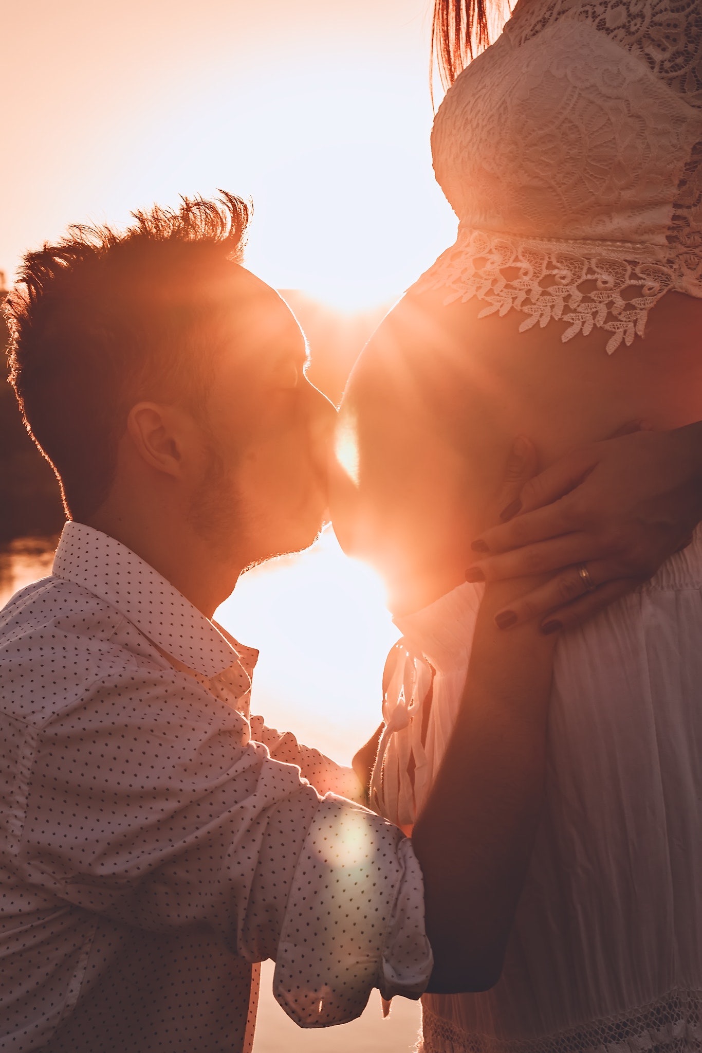 Мужчина целует жену. Мужчина и женщина любовь. Целует беременный животик. Поцелуй беременной.